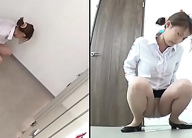 Japanese saturating herself in the bathroom