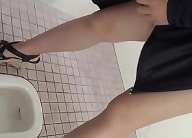Squatting asians urinate in public toilet