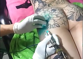 Exotic Asian beauty flaunts Rococo full-body tattoos in dampness Vietnamese nights.